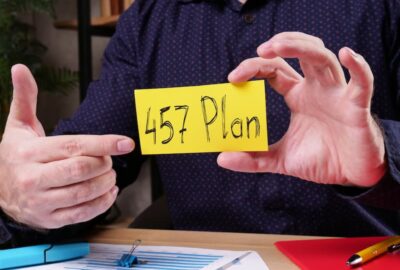 Man holding and pointing to a card that says "$57 Plan".