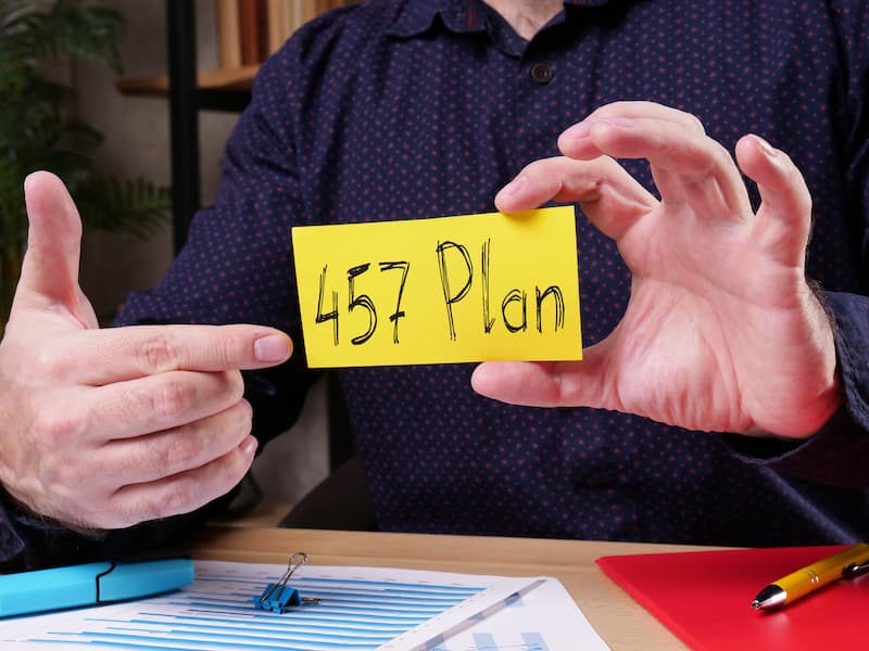 Man holding and pointing to a card that says "$57 Plan".