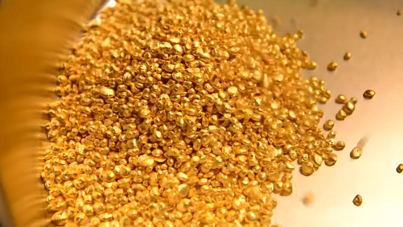 A pile of gold flakes, representing an investment with Birch Gold Group