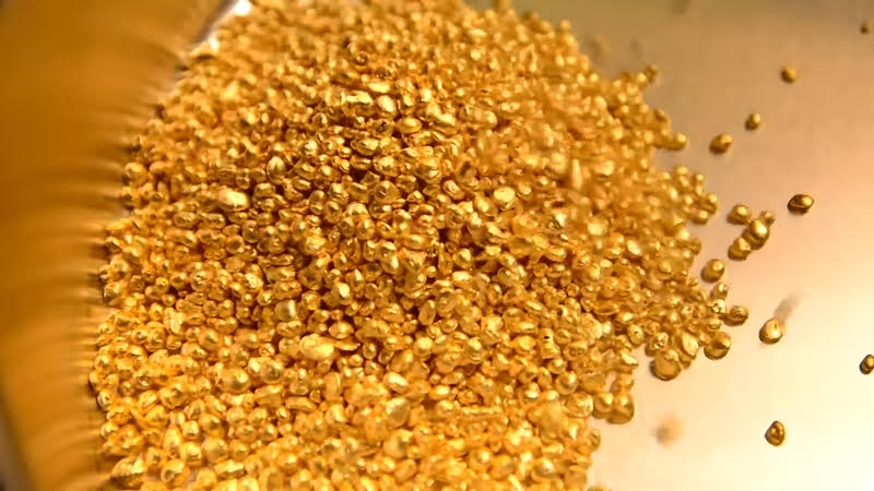 A pile of gold flakes, representing an investment with Birch Gold Group