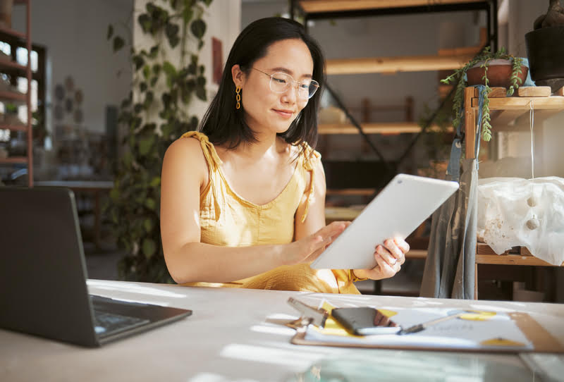 A woman managing her investment portfolio on a tablet