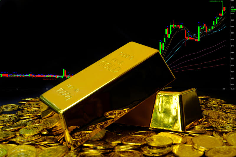 A pile of gold bars and coins, representing the future of gold investing